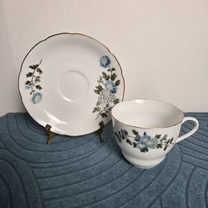 Porcelain Tea Cup and Saucer Set with Blue Floral Motif and Gold Trim